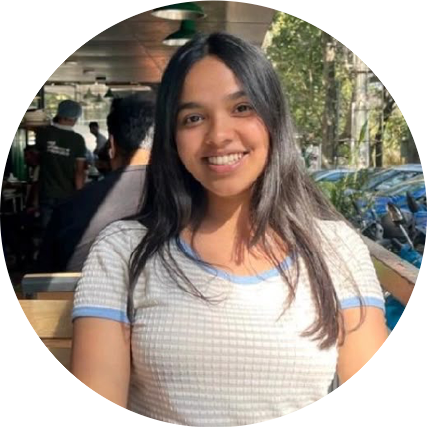 Kavya Rajeevan smiling at a café